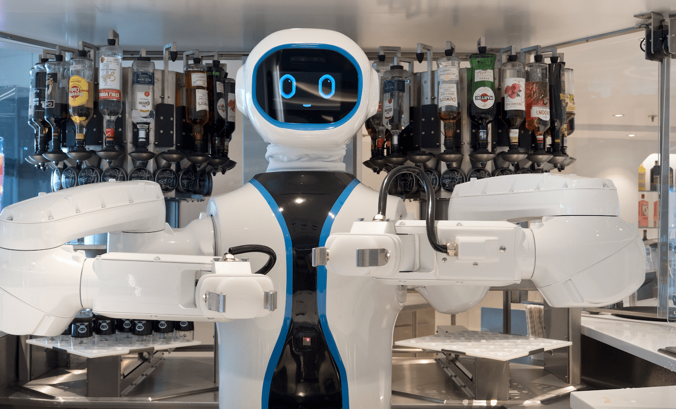 A goofy-looking robot bartender on a cruise ship, with a rack of various liquors behind it.