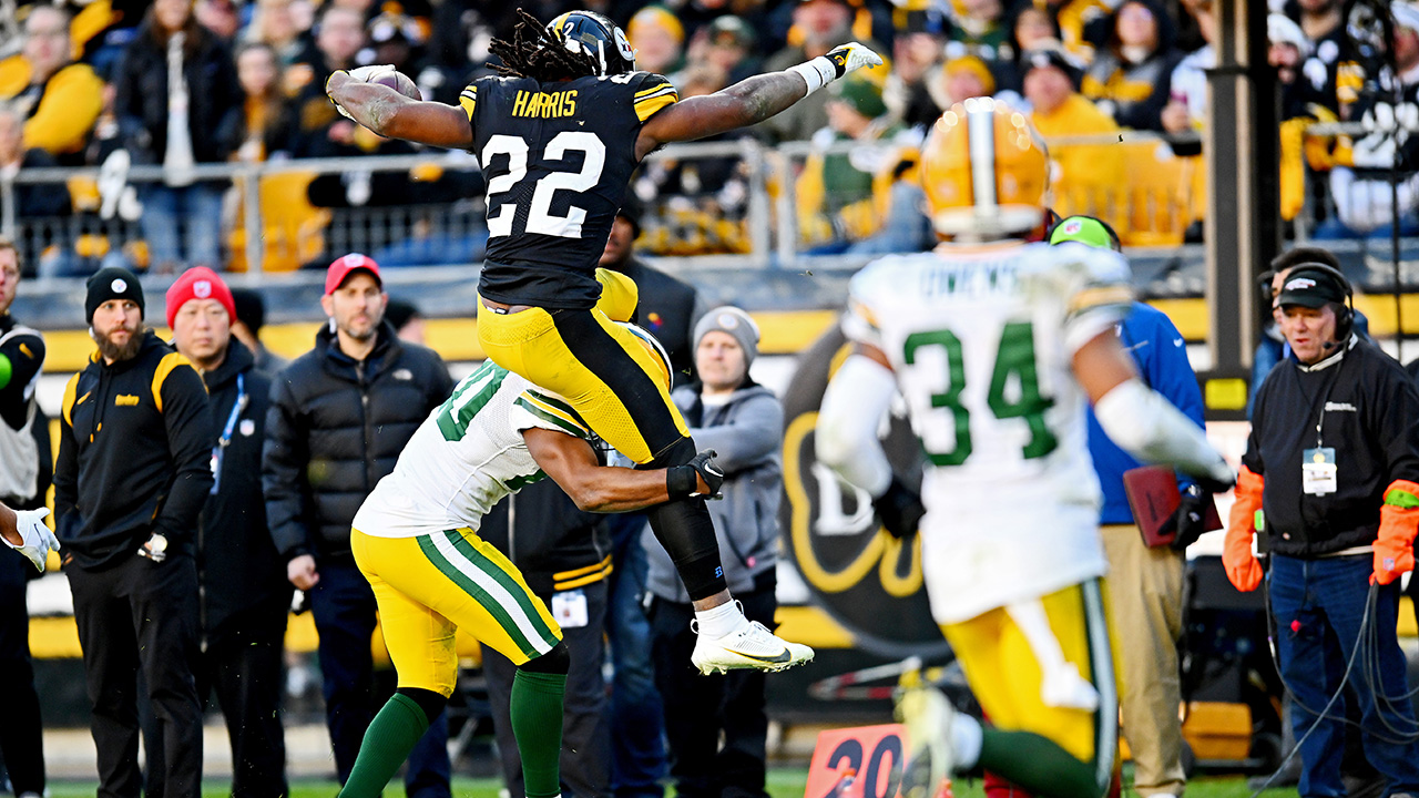 Najee Harris #22 of the Pittsburgh Steelers hurdles Rudy Ford #20 of the Green Bay Packers during the fourth quarter at Acrisure Stadium on November 12, 2023 in Pittsburgh, Pennsylvania.