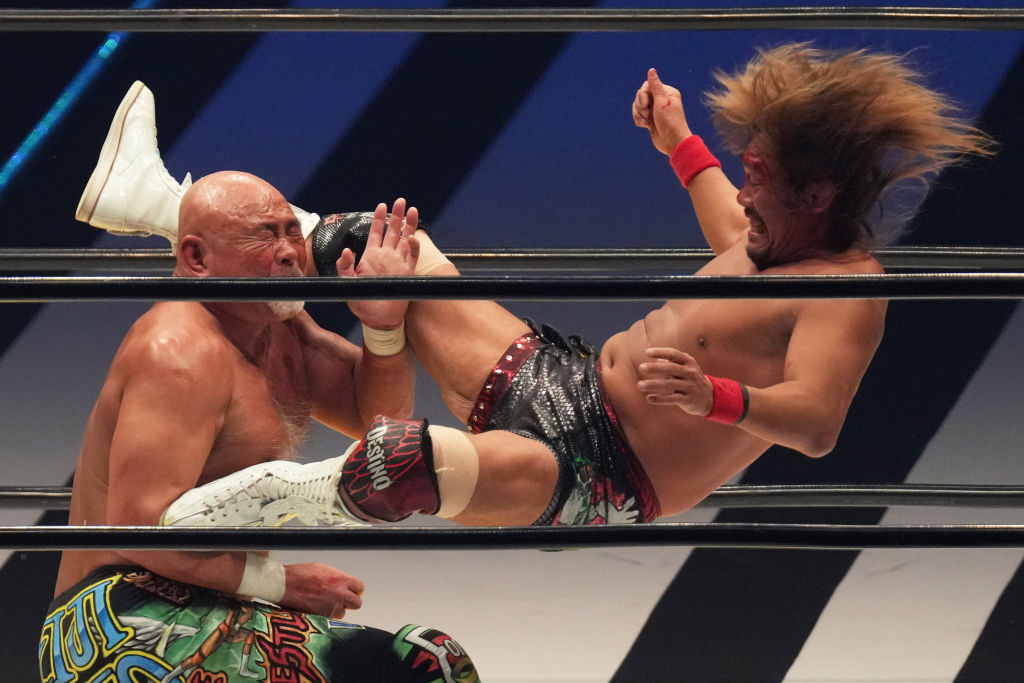 Tetsuya Naito flying in with a knee on Keiji Muto
