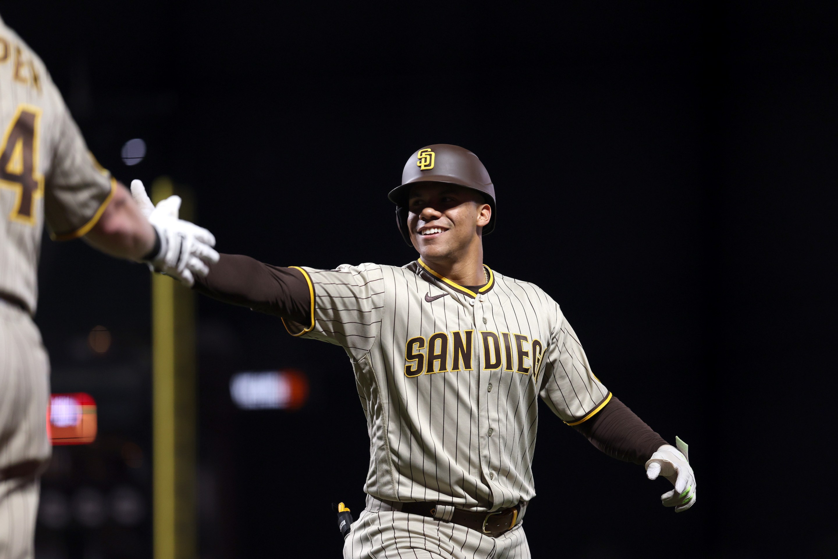 Juan Soto, then of the San Diego Padres, high-fives a teammate during a road game against the Giants.