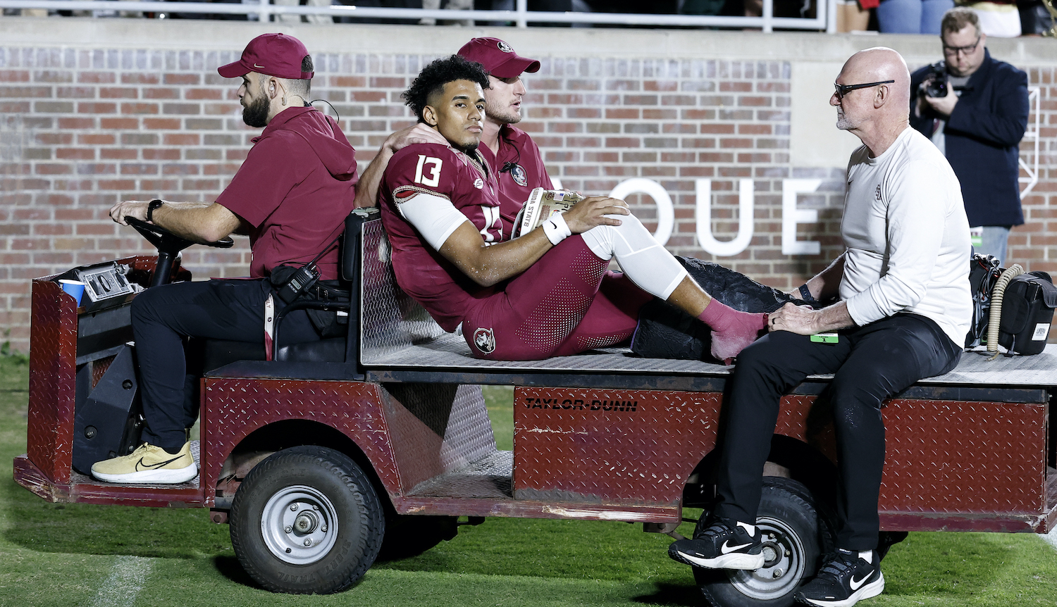 TALLAHASSEE, FL - NOVEMBER 18: Quarterback Jordan Travis #13 of the Florida State Seminoles is carted off the field after an ankle jury during the game against the North Alabama Lions on Bobby Bowden Field at Doak Campbell Stadium on November 18, 2023 in Tallahassee, Florida. The 4th ranked Seminoles defeated the Lions 58 to 13. (Photo by Don Juan Moore/Getty Images) *** Local Caption *** Jordan Travis
