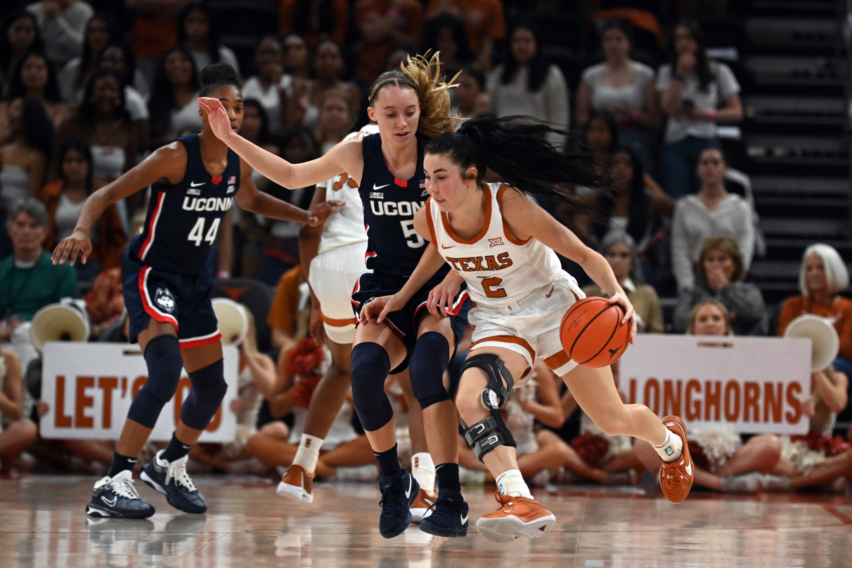 AUSTIN, TX - DECEMBER 03: Texas Longhorns guard Shaylee Gonzalez (2) drives past UConn Huskies guard Paige Bueckers (5) during game featuring the Connecticut Huskies and Texas Longhorns on December 3, 2023, at the Moody Center in Austin, TX.