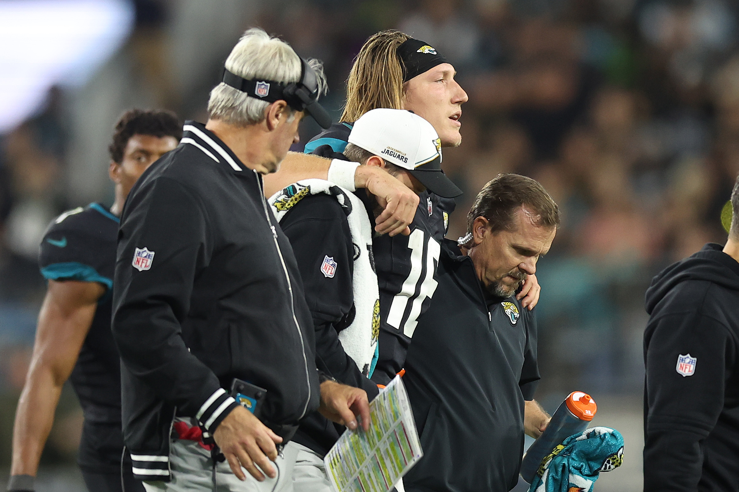 JACKSONVILLE, FLORIDA - DECEMBER 04: Trevor Lawrence #16 of the Jacksonville Jaguars is helped up by head coach Doug Pederson after being injured against the Cincinnati Bengals during the fourth quarter at EverBank Stadium on December 04, 2023 in Jacksonville, Florida. (Photo by Mike Carlson/Getty Images)