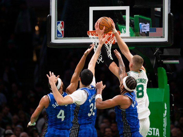 Kristaps Porzingis dunks over three Orlando Magic players.