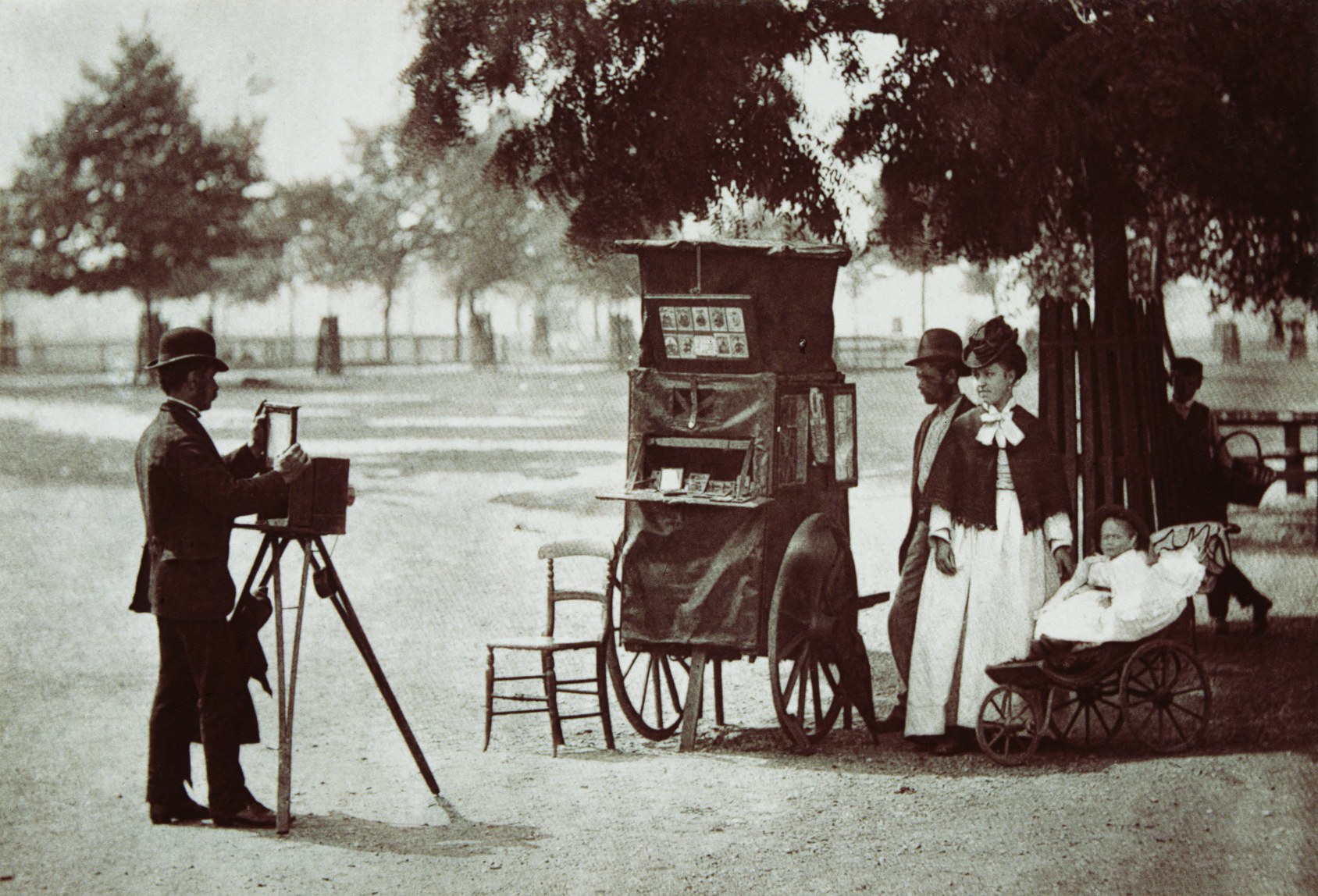 black and white photo of a man photographing a family