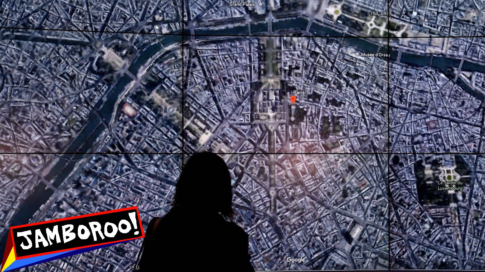 A woman staring at a large map of Paris