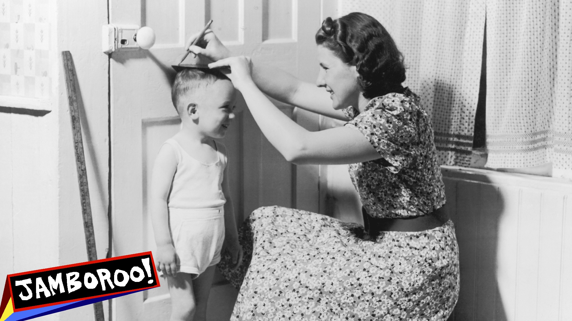 A mother marks her son's height on the door with a pencil, circa 1950. (Photo by FPG/Hulton Archive/Getty Images)