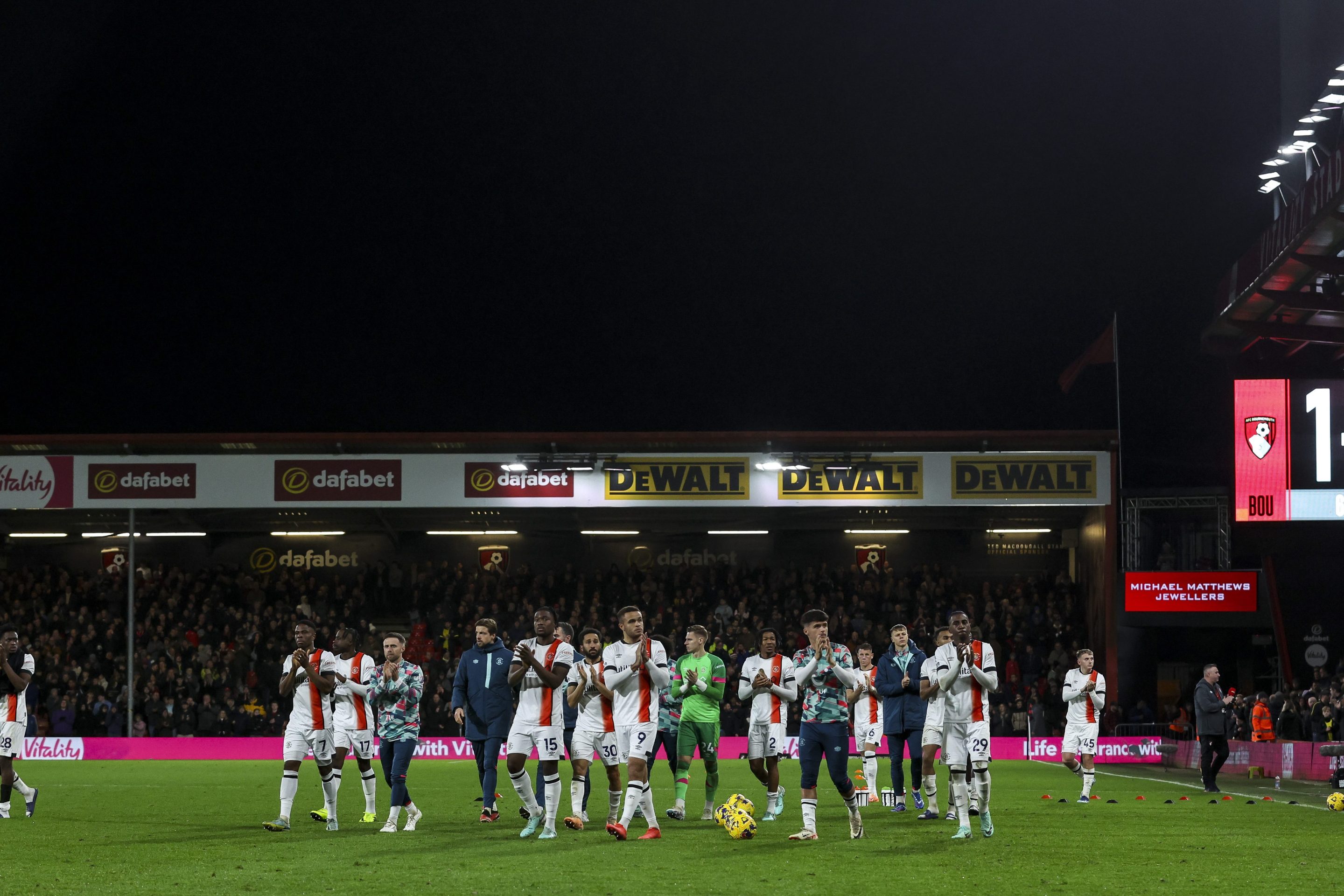 Luton Town players applaud fans after game was abandoned after team-mate Tom Lockyer needed lengthy medical treatment before being stretchered off during the Premier League match between AFC Bournemouth and Luton Town at Vitality Stadium on December 16, 2023 in Bournemouth, England.