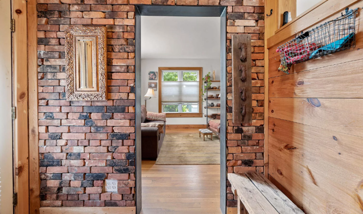 entryway with brick wall