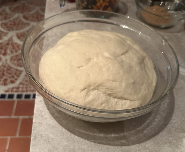 The same bowl with dough that has risen.