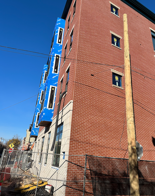 brick building with wire going through the wall