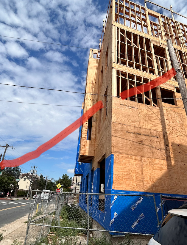 same image as above with a highlighted wire shown going through the building.