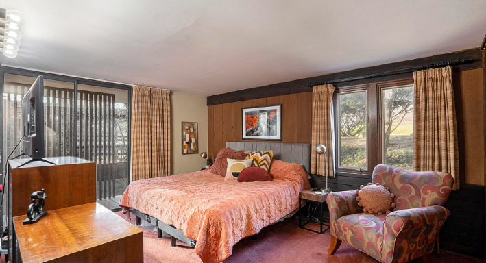 bedroom with tufted wall and plush carpet!