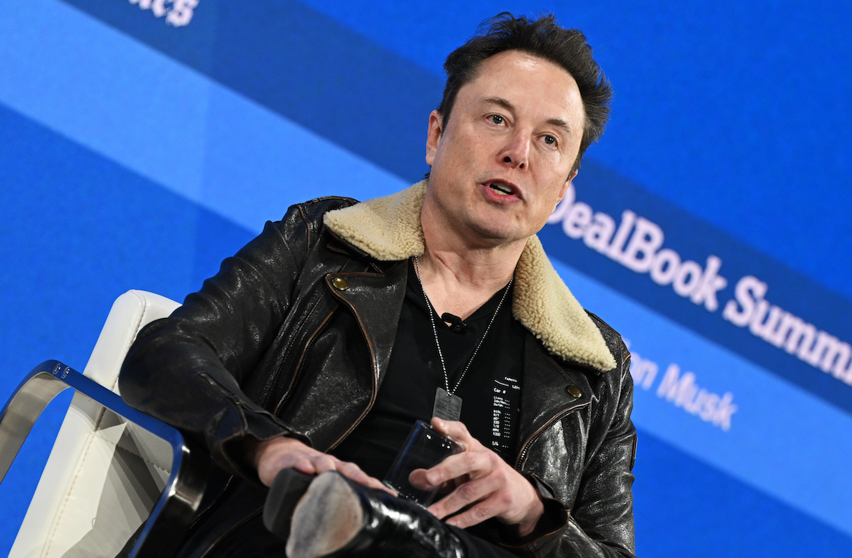 Elon Musk wearing a black leather jacket with a shearling collar to a stage interview with Andrew Ross Sorkin, lol.