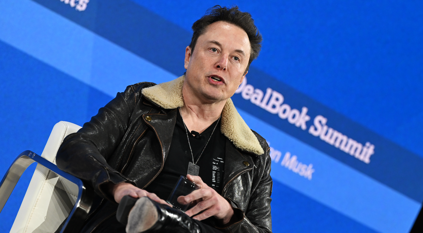 Elon Musk wearing a black leather jacket with a shearling collar to a stage interview with Andrew Ross Sorkin, lol.