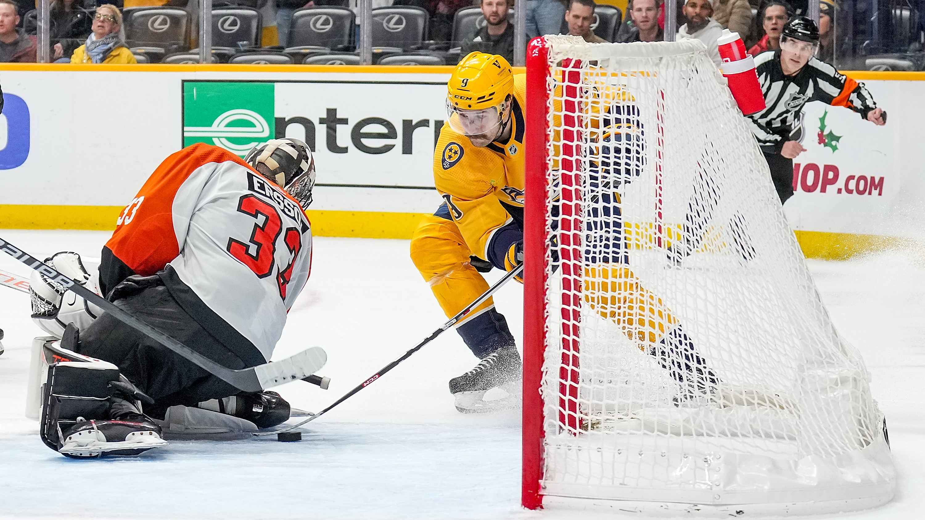 Filip Forsberg #9 of the Nashville Predators retrieves a loose puck from Samuel Ersson #33 of the Philadelphia Flyers to score the overtime game winning goal.