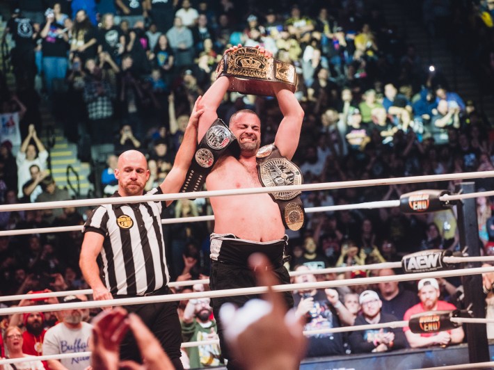 Eddie Kingston holds up his title belt at AEW Worlds End.