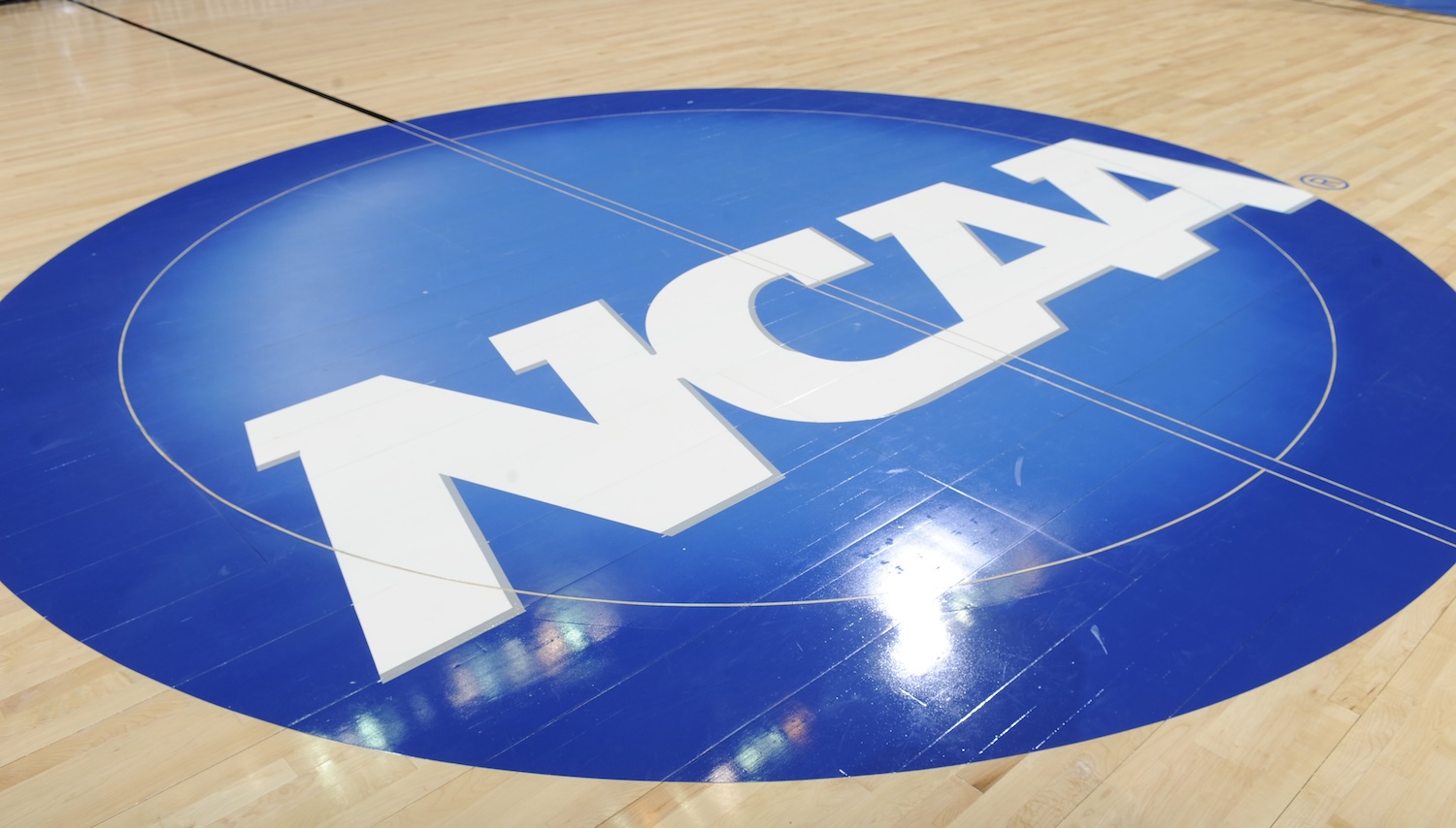 WASHINGTON, DC - MARCH 19: The NCAA logo on the basketball court during the third round of the 2011 NCAA men's basketball tournament between the Butler Bulldogs and the Pittsburgh Panthers at the Verizon Center on March 19, 2011 in Washington, DC. The Bulldogs won 71-70. (Photo by Mitchell Layton/Getty Images)