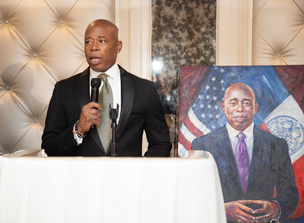 New York Mayor Eric Adams speaking at Healing for Heroes Gala in Brooklyn, in front of a painting of himself