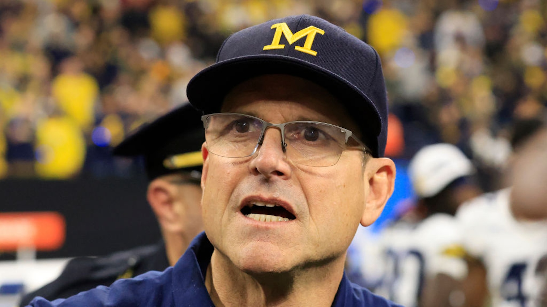 Head coach Jim Harbaugh of the Michigan Wolverines walks on the field after winning the Big Ten Championship against the Iowa Hawkeyes at Lucas Oil Stadium on December 02, 2023 in Indianapolis, Indiana.