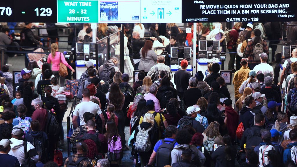 Passengers wait in the TSA screening line