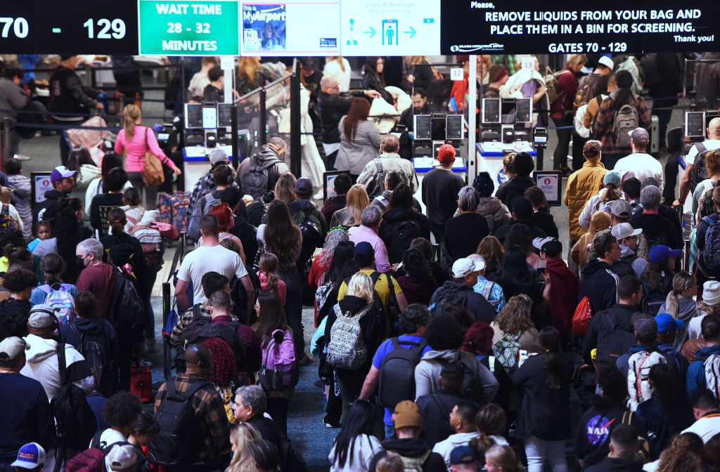 Passengers wait in the TSA screening line