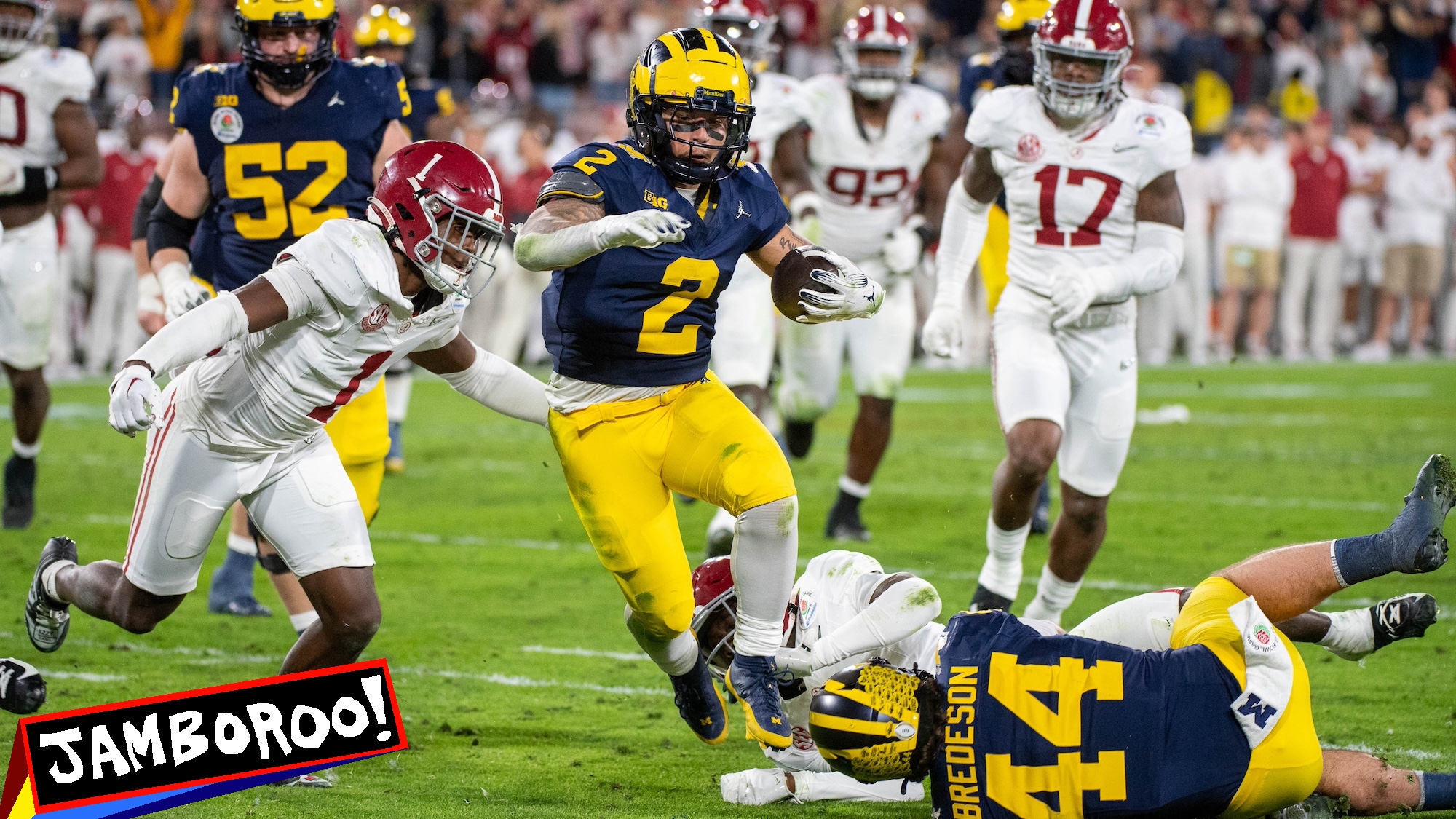 PASADENA, CALIFORNIA - JANUARY 01: Blake Corum #2 of the Michigan Wolverines runs with the ball for yardage away from Terrion Arnold #3 and Kool-Aid McKinstry #1 of the Alabama Crimson Tide during second half of the CFP Semifinal Rose Bowl Game at Rose Bowl Stadium on January 01, 2024 in Pasadena, California. The Michigan Wolverines won the game 27-20 in overtime. (Photo by Aaron J. Thornton/Getty Images)
