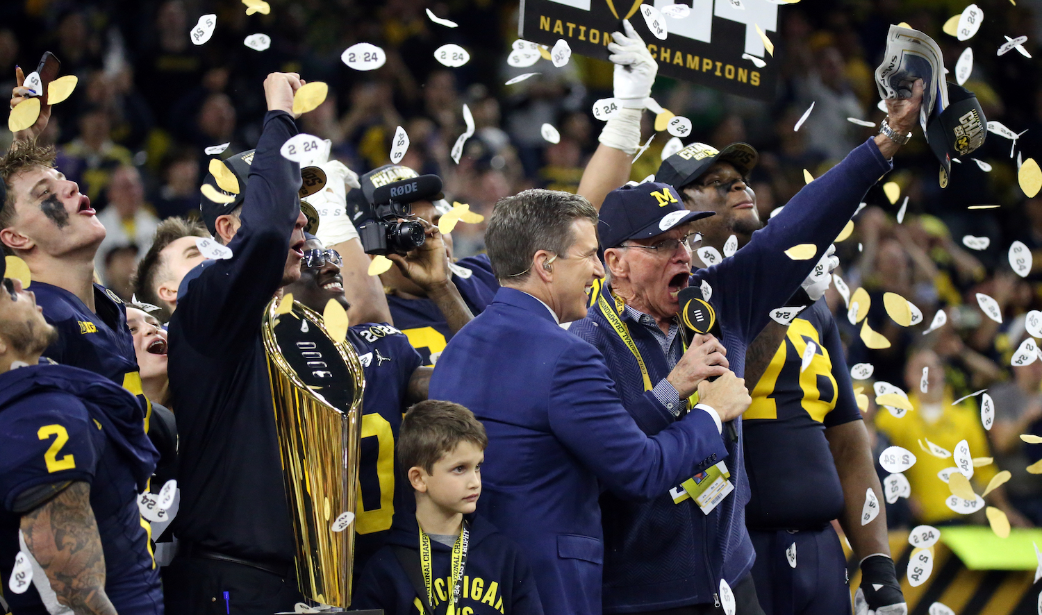 HOUSTON, TX - JANUARY 08: Jack Harbaugh, father of Head Coach Jim Harbaugh of the Michigan Wolverines, leads the fans in a chant to celebrate winning the game during the Michigan Wolverines versus the Washington Huskies CFP National Championship game on January 8, 2024, at NRG Stadium in Houston, TX. (Photo by Leslie Plaza Johnson/Icon Sportswire)