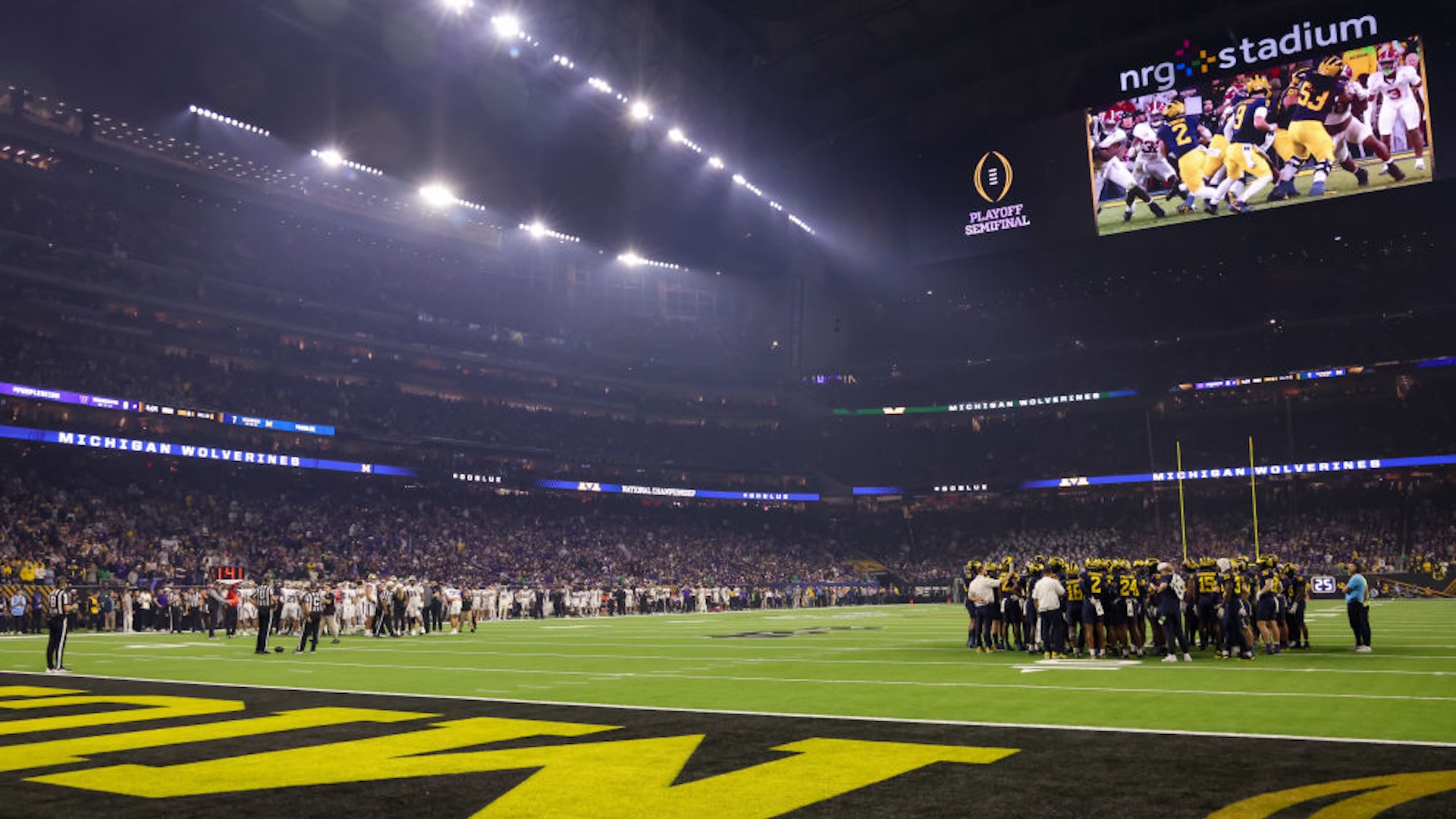 The teams huddle up just before the start of the CFP National Championship game Michigan Wolverines and Washington Huskies on January 8, 2024, at NRG Stadium in Houston, Texas.