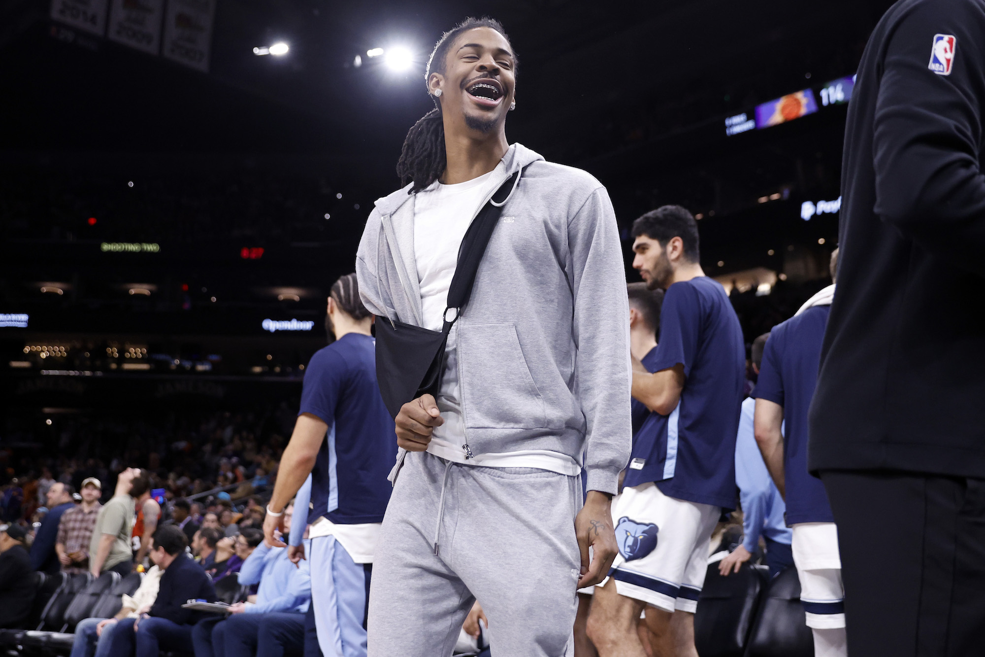 Ja Morant walks with his arm in a sling