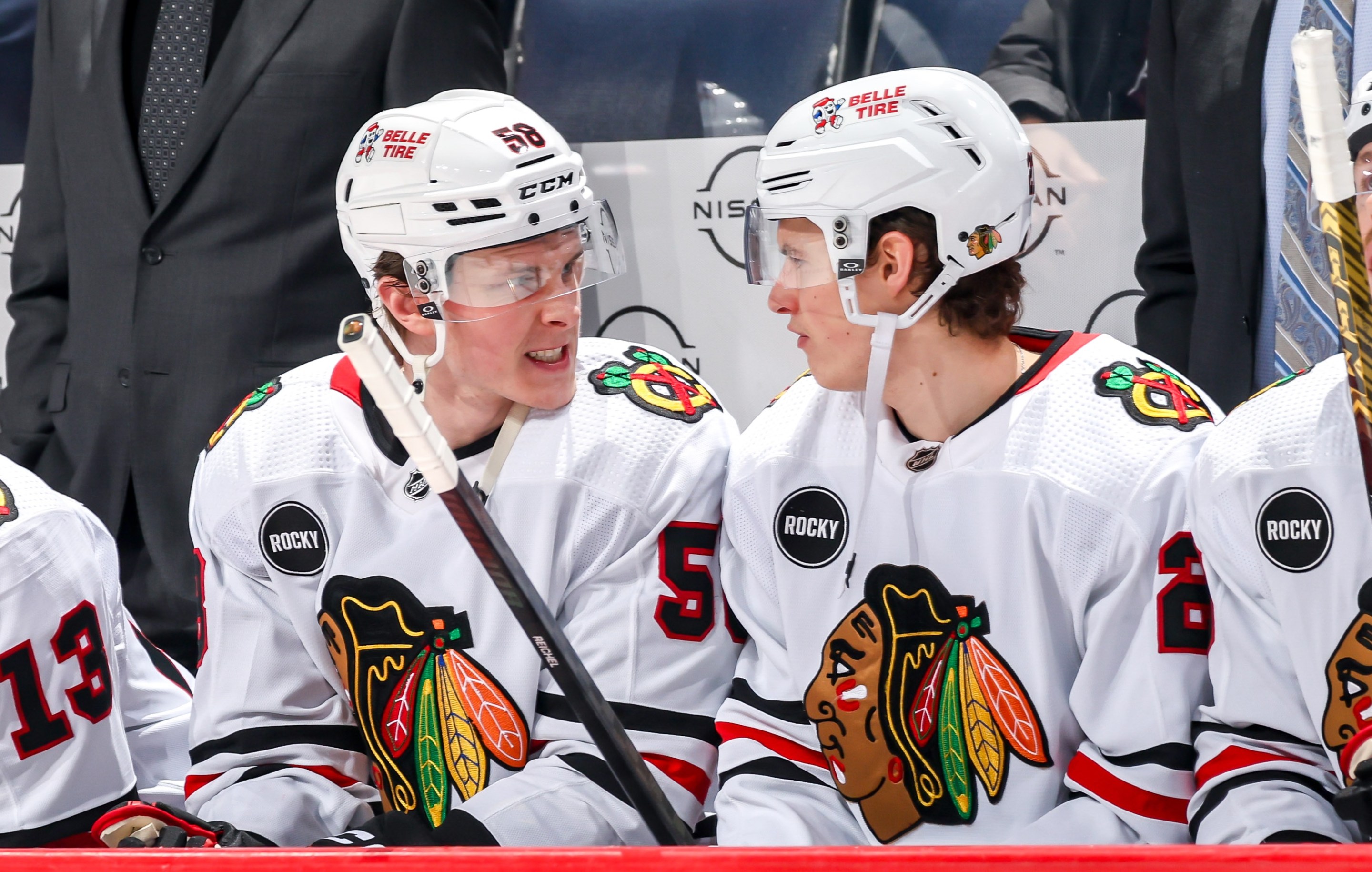 WINNIPEG, CANADA - JANUARY 11: MacKenzie Entwistle #58 and Lukas Reichel #27 of the Chicago Blackhawks get set at the bench prior to puck drop against the Winnipeg Jets at the Canada Life Centre on January 11, 2024 in Winnipeg, Manitoba, Canada. (Photo by Jonathan Kozub/NHLI via Getty Images)