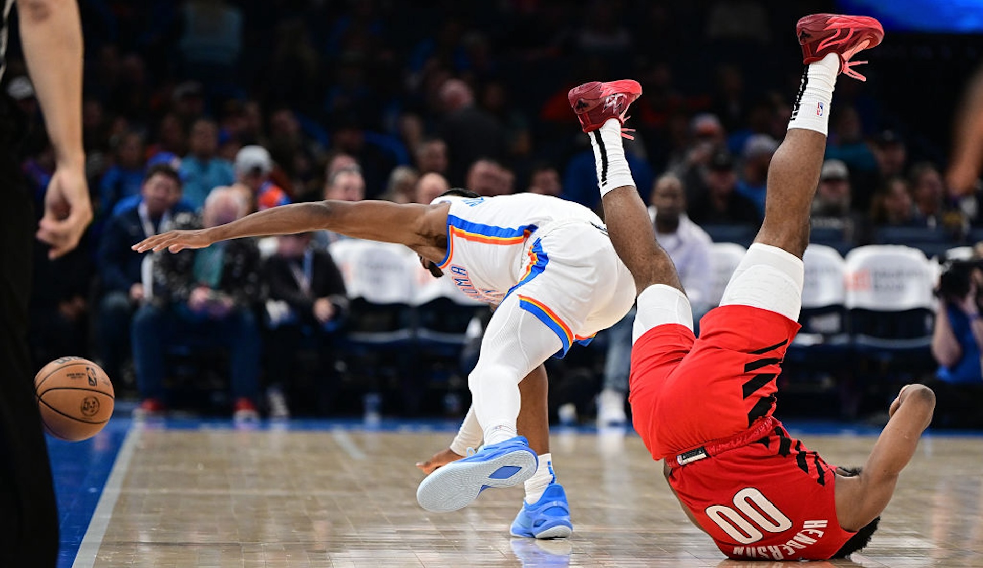 Scoot Henderson #00 of the Portland Trail Blazers and Shai Gilgeous-Alexander #2 of the Oklahoma City Thunder tumble after a loose ball during the second half at Paycom Center on January 11, 2024 in Oklahoma City, Oklahoma. NOTE TO USER: User expressly acknowledges and agrees that, by downloading and or using this Photograph, user is consenting to the terms and conditions of the Getty Images License Agreement.