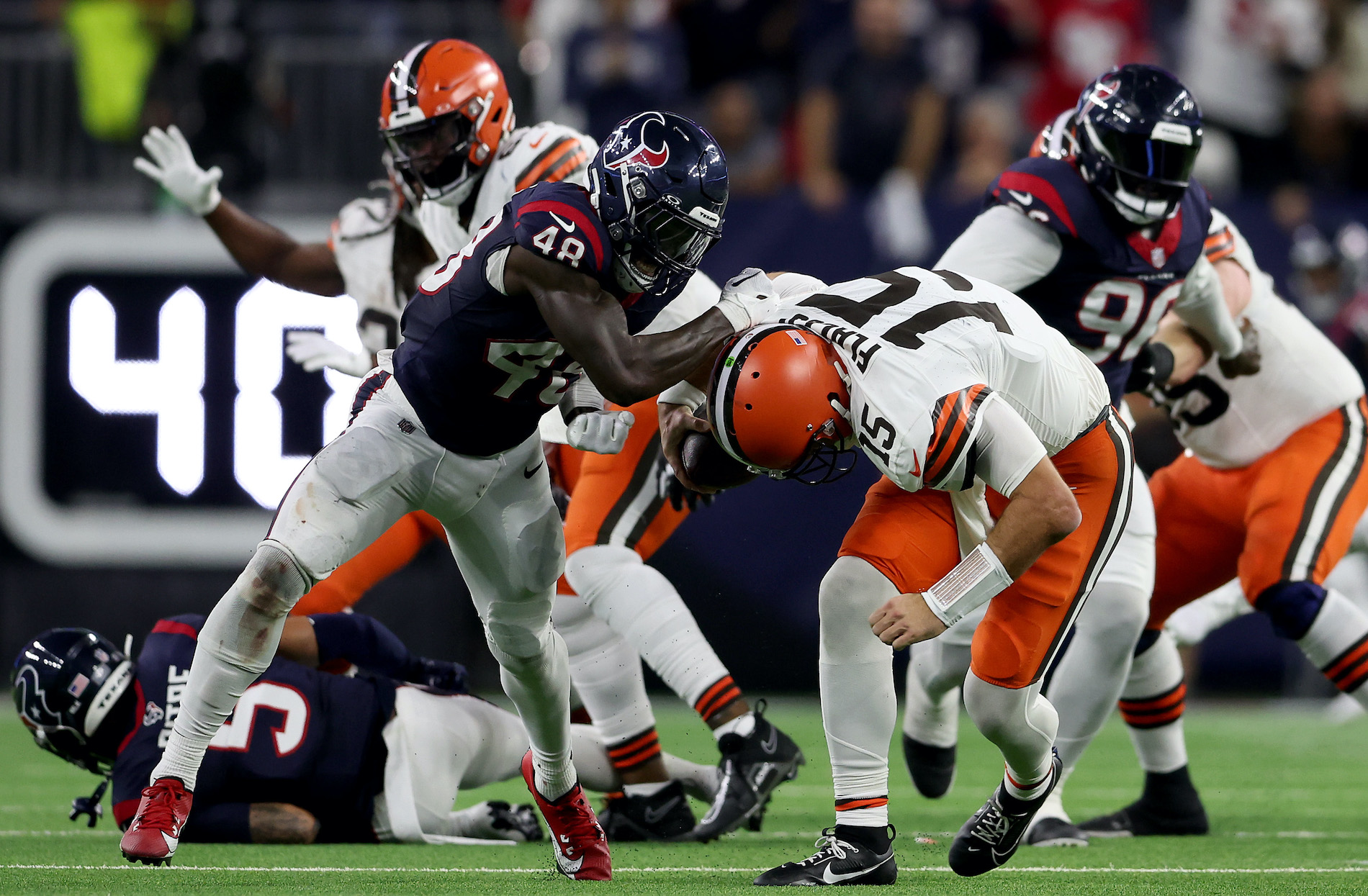 Christian Harris drags Joe Flacco to the ground in the Browns-Texans wild card game.