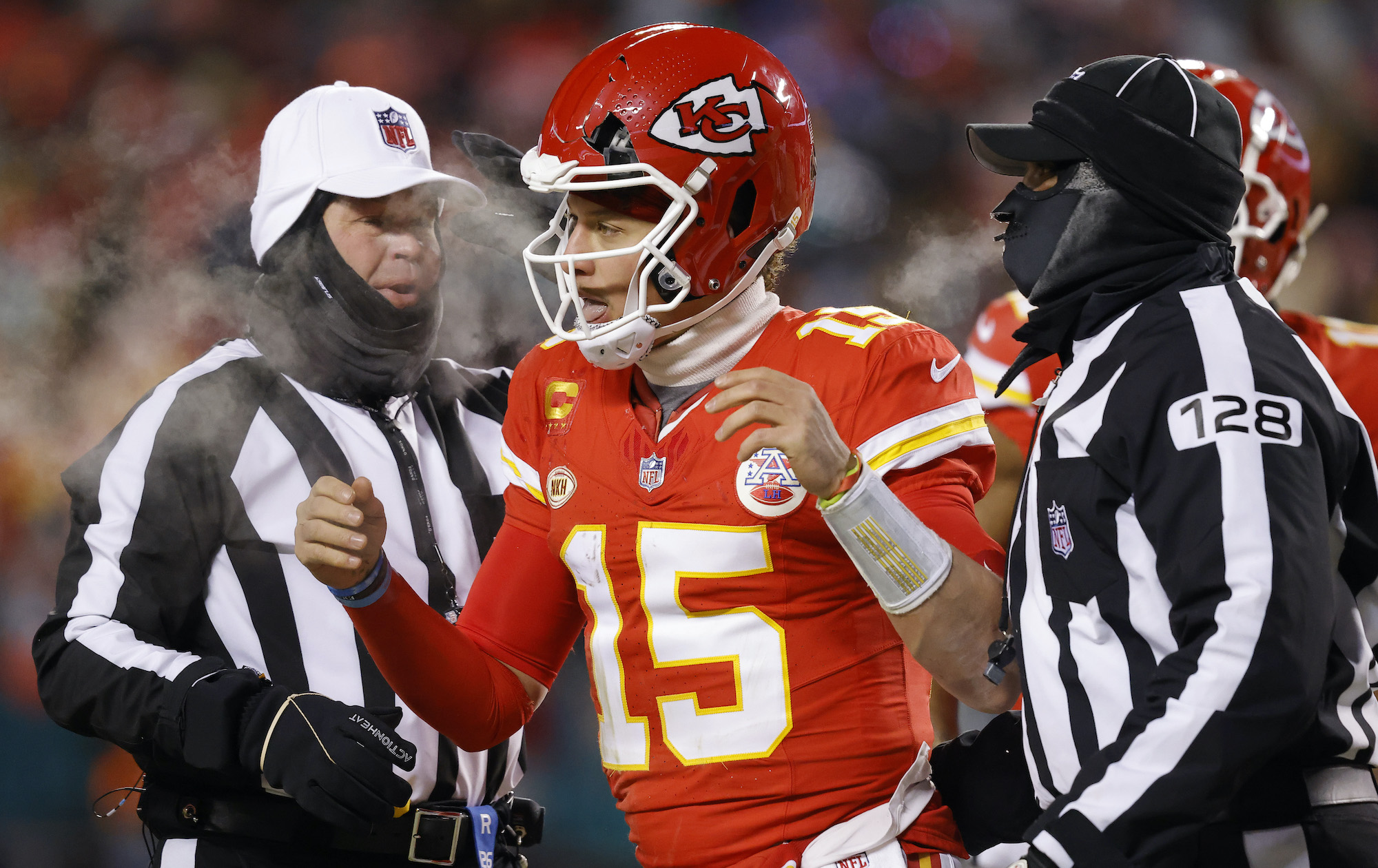 Patrick Mahomes of the Chiefs has a cracked helmet during Saturday's playoff game against the Dolphins.