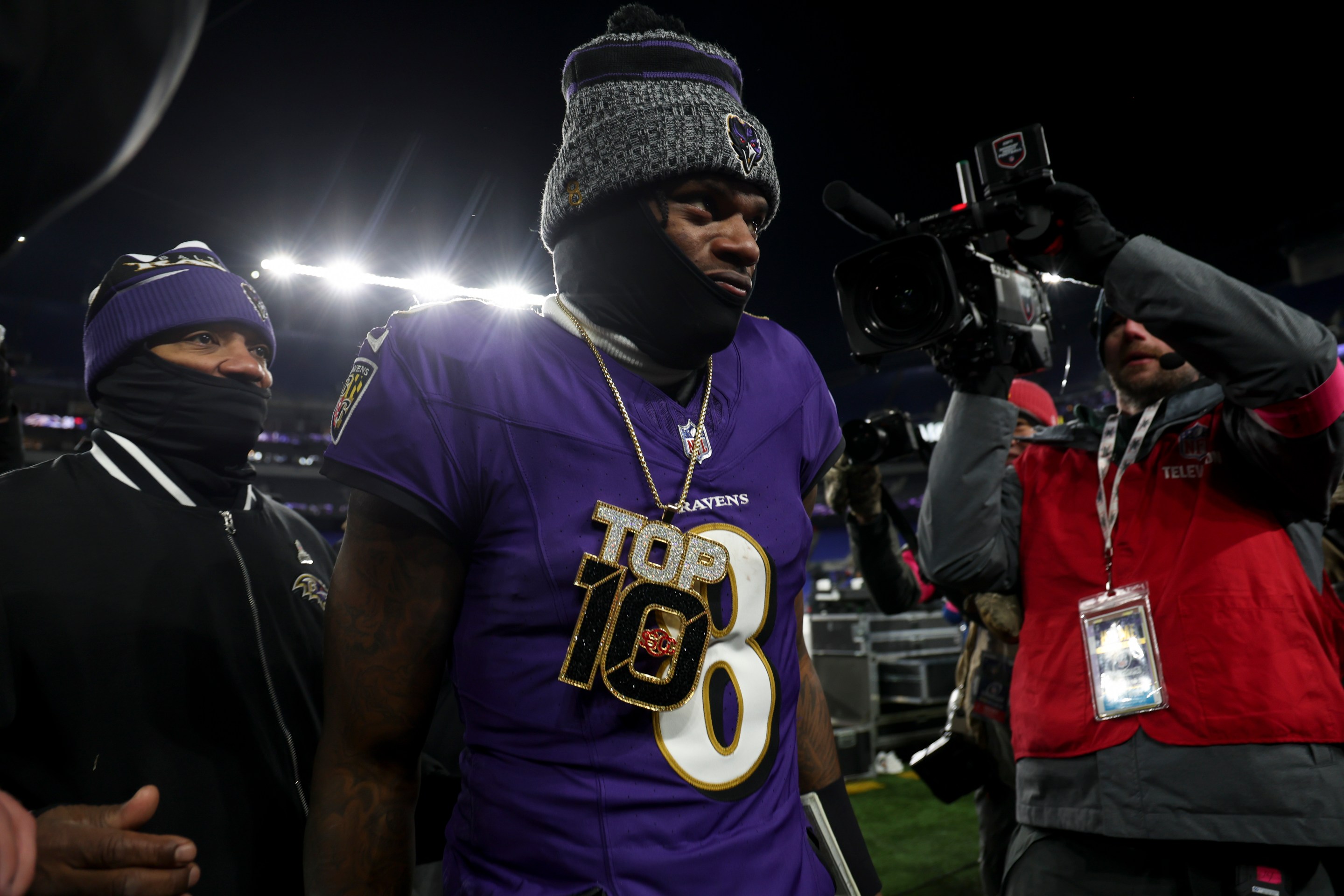 Lamar Jackson #8 of the Baltimore Ravens wears a "Top 10" chain as he walks off of the field after an NFL Divisional Round playoff game against the Houston Texans at M&amp;T Bank Stadium on January 20, 2024 in Baltimore, Maryland.