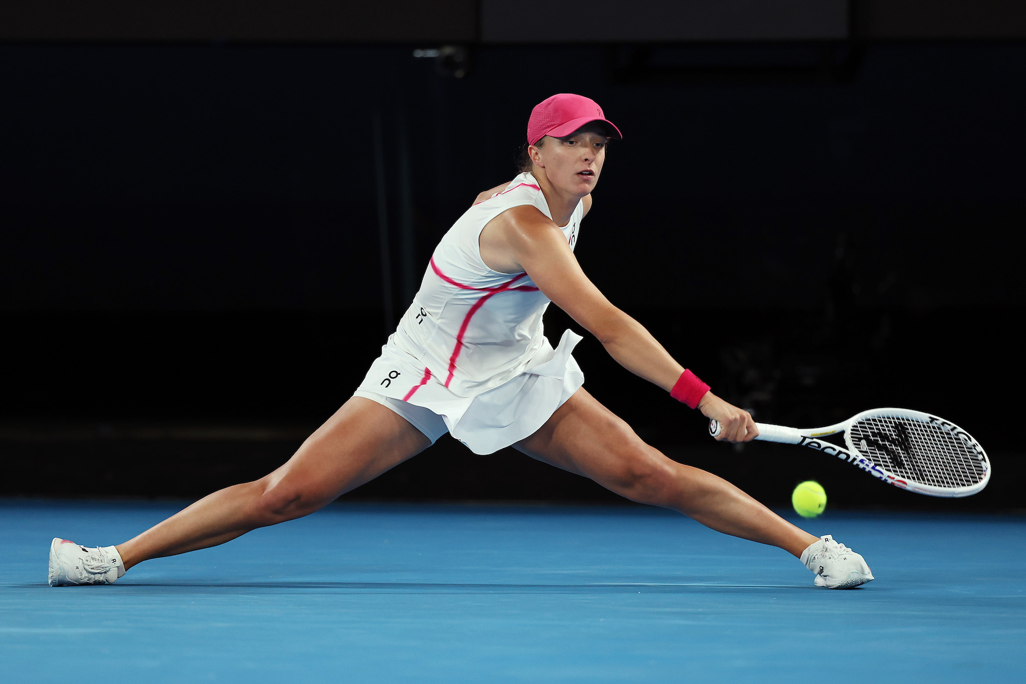 Iga Swiatek slides in her second-round Australian Open match