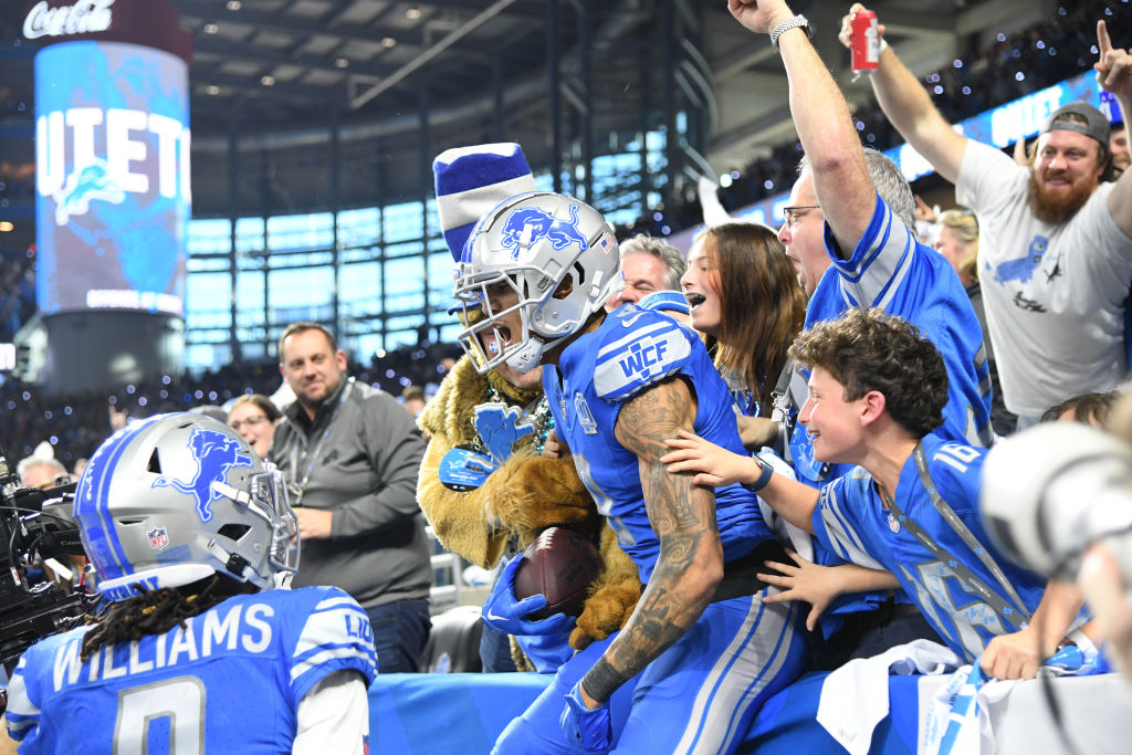 Josh Reynolds jumps into the stands after a touchdown catch