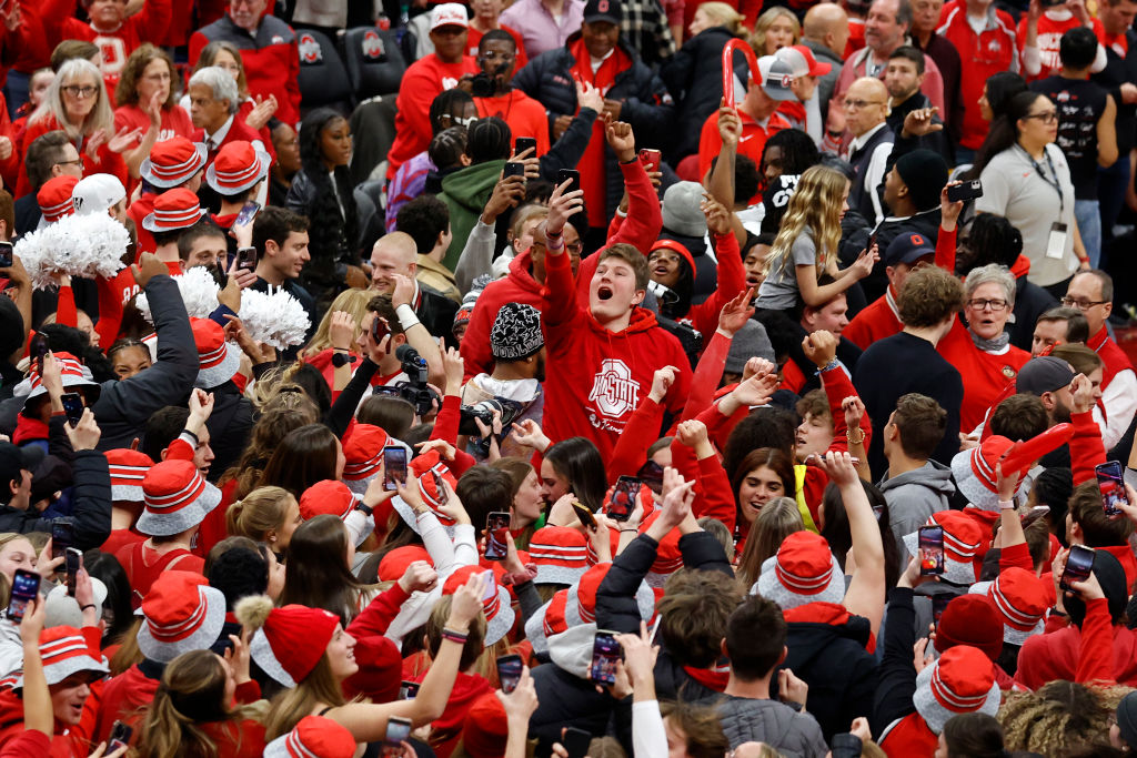 Fans celebrate on the floor after the Ohio State Buckeyes defeated the Iowa Hawkeyes in overtime on January 21, 2024, at Value City Arena in Columbus, Ohio.