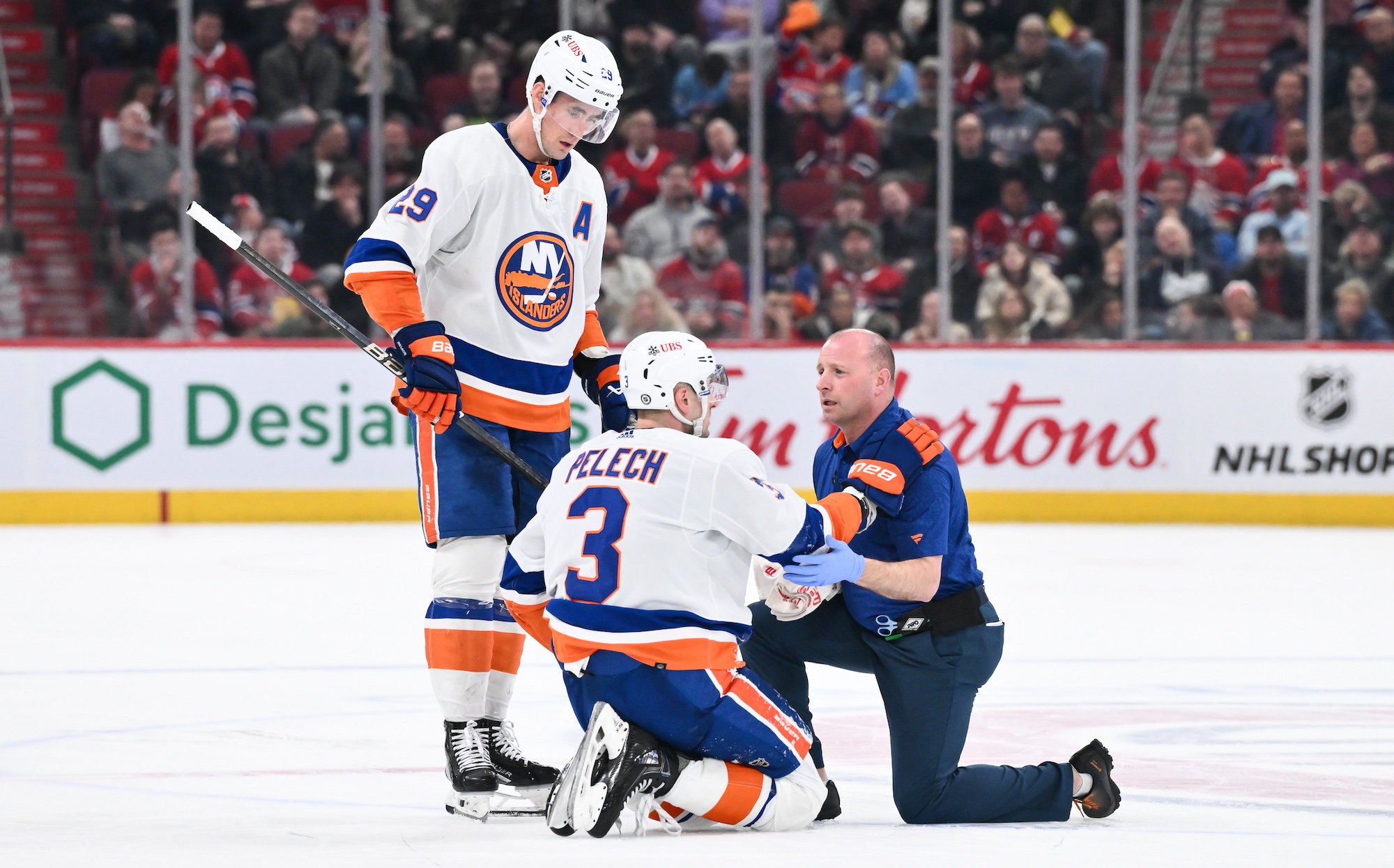 Medical staff tend to Adam Pelech #3 of the New York Islanders during the third period Montreal Canadiens at the Bell Centre on January 25, 2024 in Montreal, Quebec, Canada. The Montreal Canadiens defeated the New York Islanders 4-3. (Photo by Minas Panagiotakis/Getty Images)