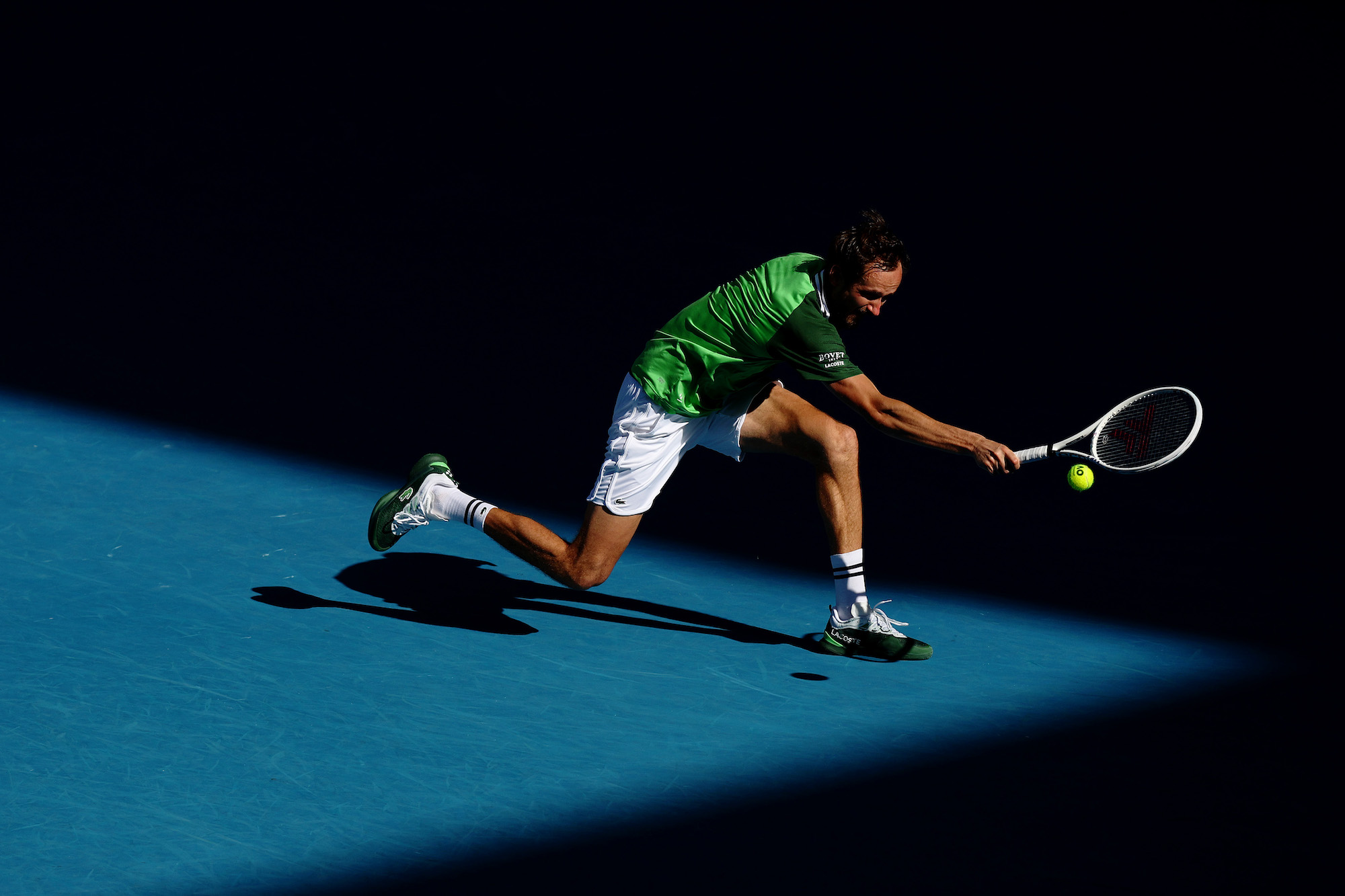 Daniil Medvedev retrieves a ball in his Australian Open quarterfinal against Hubi Hurkacz