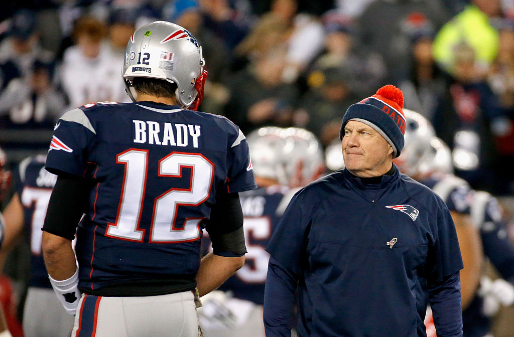 Bill Belichick talks with Tom Brady before a game