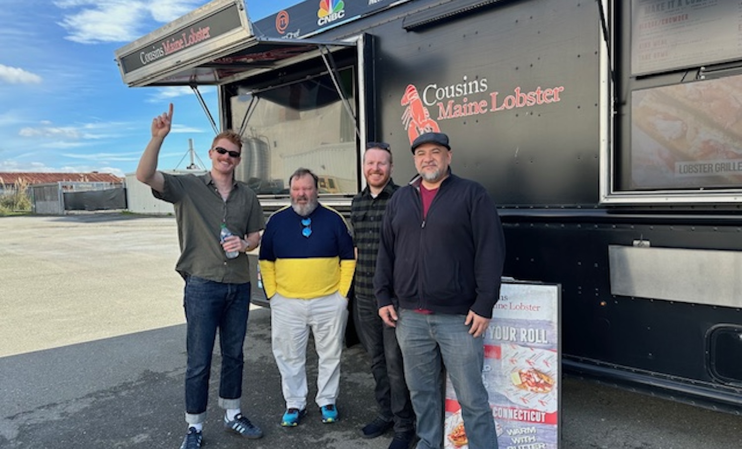 The Ray Ratto raffle winners, along with Ray Ratto and Patrick Redford, enjoying some lobster from a truck.