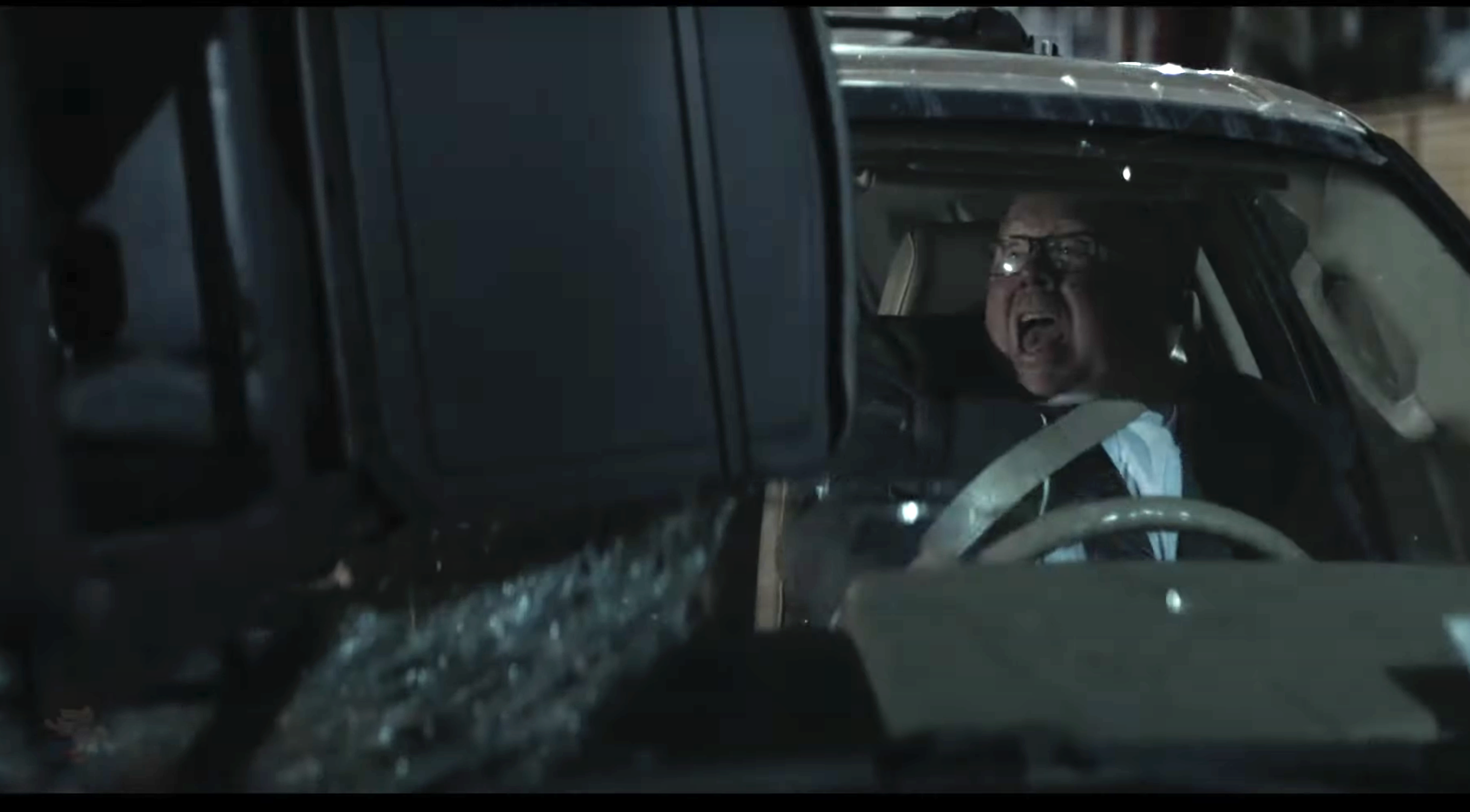 A bad guy reacts to having a grill thrown through his windshield by Jack Reacher