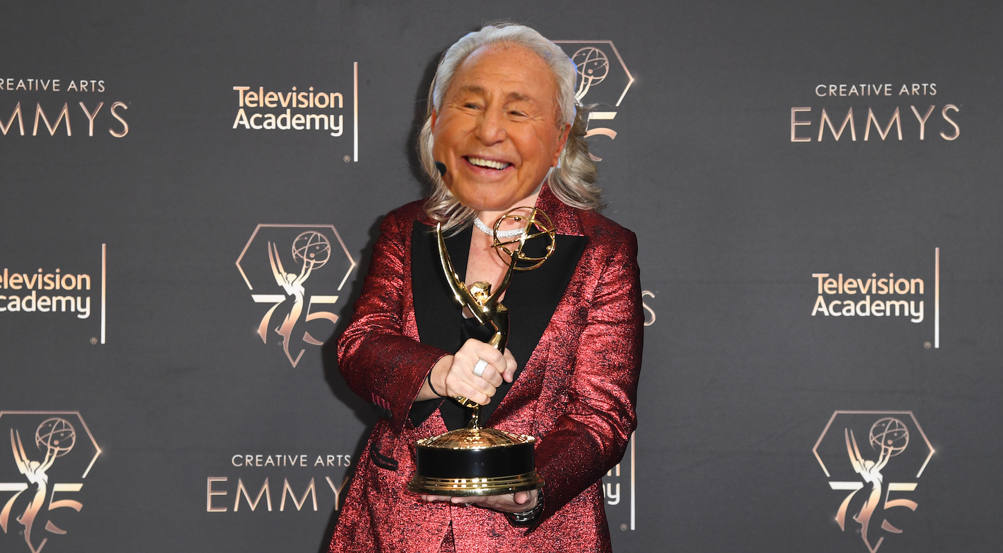 A photo of Liz Patrick with her Emmy Award, and with Lee Corso's face clumsily pasted on top of hers.