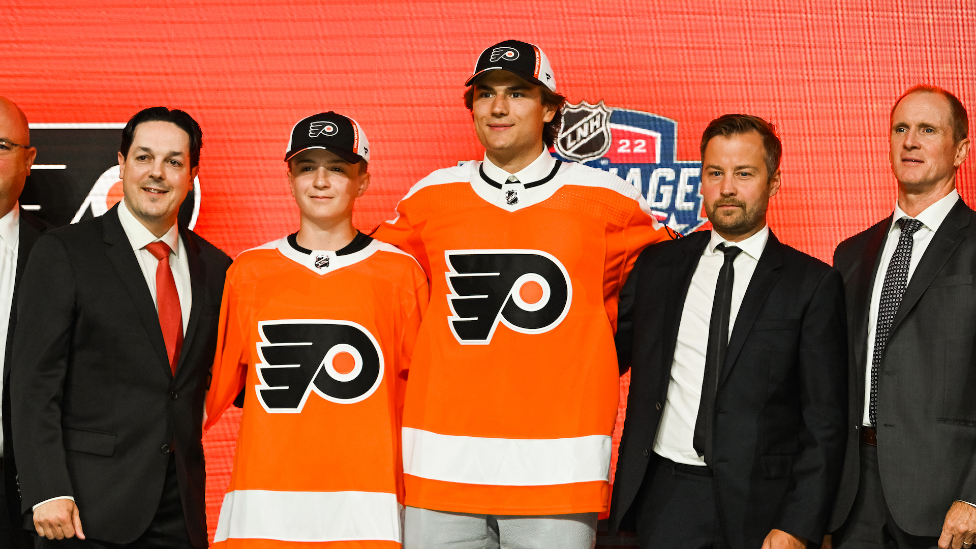 Philadelphia Flyers pick Cutter Gauthier stands between management during the first round of the 2022 NHL Entry Draft, including Danny Briere.