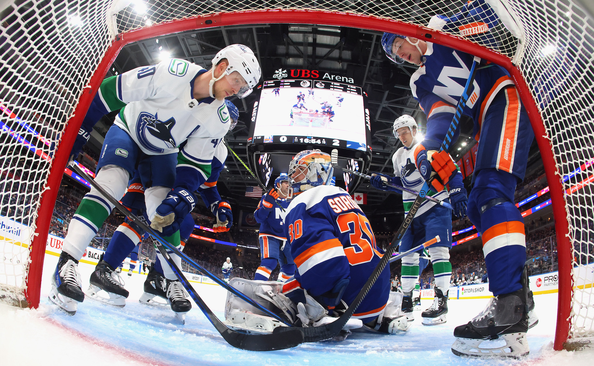 Ilya Sorokin #30 of the New York Islanders makes the save on Elias Pettersson #40 of the Vancouver Canucks.