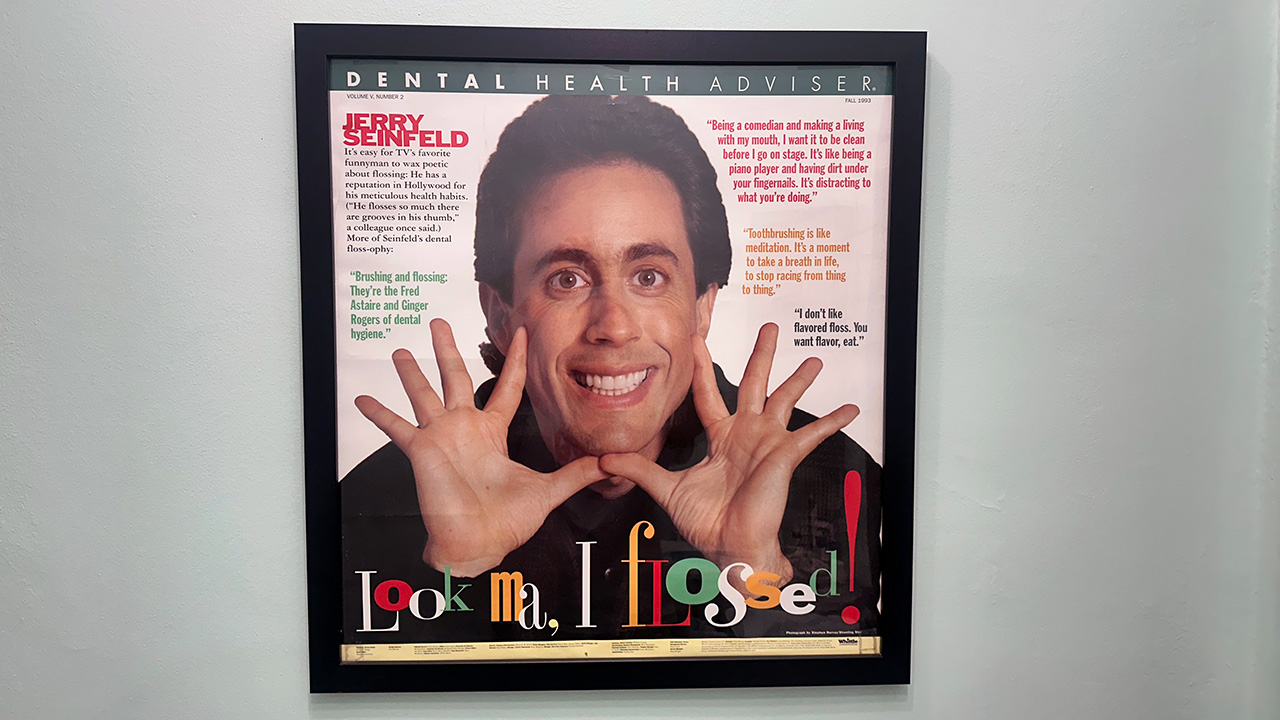 A poster of Jerry Seinfeld showing his perfect teeth. It's Dental Health Adviser from Fall 1993, and it's a large poster. It's telling you to floss.