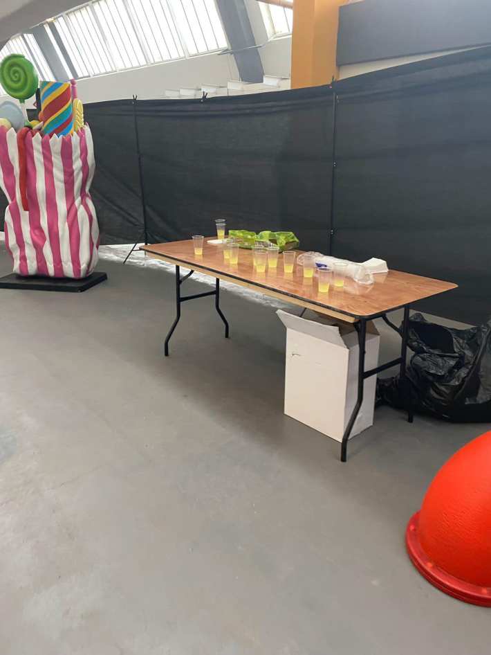 A table with a few small cups of lemonade on it