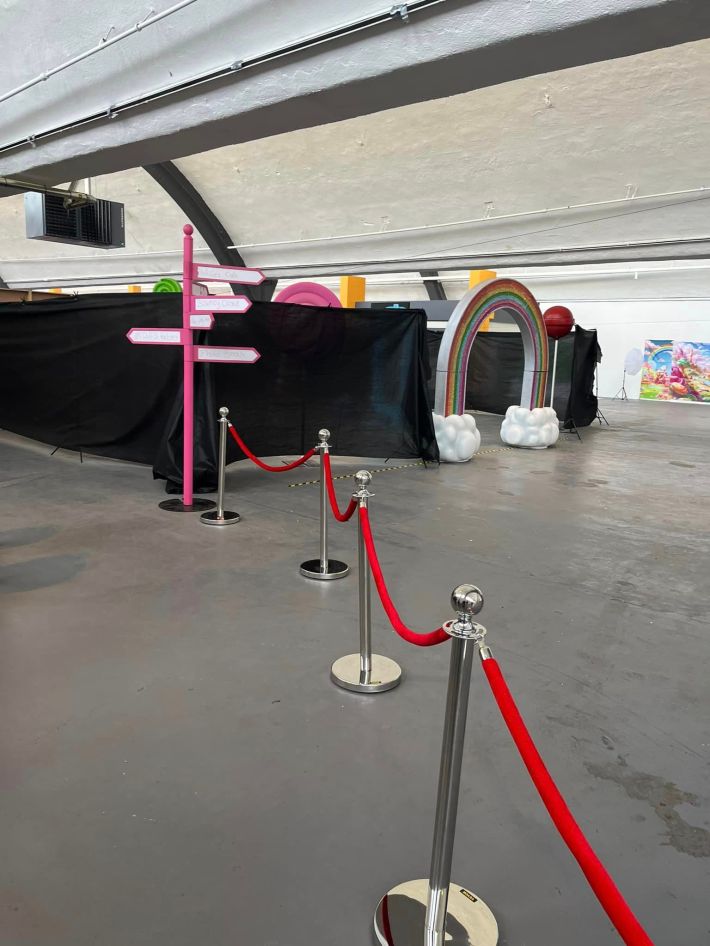A sparsely decorated warehouse behind a velvet rope.
