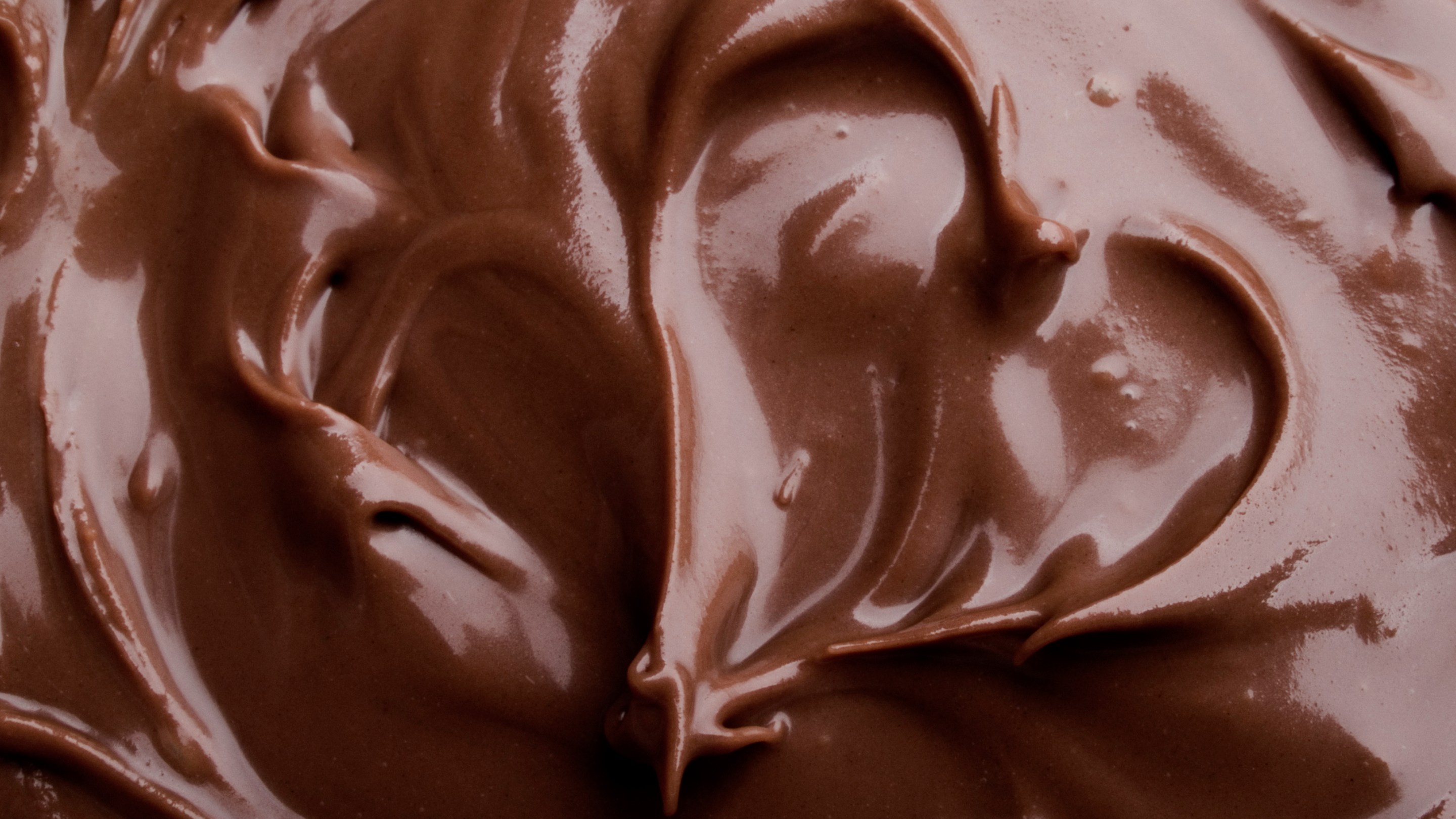 Melted chocolate with a heart shape in it.